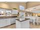 Kitchen featuring white cabinets, granite countertops, stainless steel appliances, and an island with barstool seating at 3482 W Shannon St, Chandler, AZ 85226