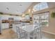 Bright kitchen featuring white cabinetry, a central island, and a charming breakfast nook with natural light at 3482 W Shannon St, Chandler, AZ 85226