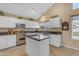 Bright kitchen featuring white cabinets, stainless steel appliances, and a functional center island at 3482 W Shannon St, Chandler, AZ 85226