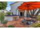 Charming patio area with a built-in grill, outdoor seating, and a shade umbrella for summer gatherings at 3482 W Shannon St, Chandler, AZ 85226