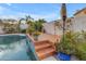 Charming pool area featuring a decorative tile waterfall and lush landscaping with a brick patio at 3482 W Shannon St, Chandler, AZ 85226