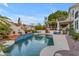 Inviting pool with a tiled deck, surrounded by mature landscaping and comfortable lounge seating at 3482 W Shannon St, Chandler, AZ 85226