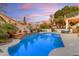 Relaxing pool area with stone accents, ambient lighting, and comfortable seating at 3482 W Shannon St, Chandler, AZ 85226