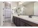 Bathroom featuring a double vanity, dark wood cabinets and a separated toilet at 3623 E Arabian Dr, Gilbert, AZ 85296