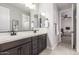 Bathroom featuring a double vanity with a dark wood cabinets and a separated mirror at 3623 E Arabian Dr, Gilbert, AZ 85296