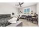 Bedroom featuring a bed, a pullout sofa, a work desk and a modern ceiling fan at 3623 E Arabian Dr, Gilbert, AZ 85296