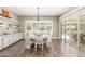 Bright dining area with a round table, white chairs, and sliding doors for lots of light at 3623 E Arabian Dr, Gilbert, AZ 85296