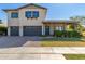 Charming two-story home with blue shutters, gray garage doors and a quaint front porch at 3623 E Arabian Dr, Gilbert, AZ 85296