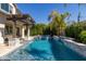 Stunning pool with a pergola, water features, and lush tropical landscaping at 3623 E Arabian Dr, Gilbert, AZ 85296