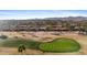 The golf course is framed by a community and the distant mountains at 3711 N 162Nd Ln, Goodyear, AZ 85395