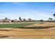 A lush green golf course winds through a community of single-Gathering homes at 3711 N 162Nd Ln, Goodyear, AZ 85395