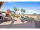 Outdoor patio featuring dining table, seating, and a fire pit, perfect for entertaining at 3711 N 162Nd Ln, Goodyear, AZ 85395