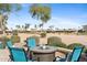 Relaxing outdoor area with a fire pit table and a stunning golf course view at 3711 N 162Nd Ln, Goodyear, AZ 85395