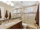 Bathroom with a granite countertop, modern fixtures, and glass shower door at 3711 N 162Nd Ln, Goodyear, AZ 85395