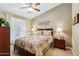 Cozy bedroom featuring a ceiling fan, natural light, and neutral tones at 3711 N 162Nd Ln, Goodyear, AZ 85395