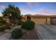 Beautiful home showcasing sunset colors, manicured landscaping, and a spacious two-car garage at 3711 N 162Nd Ln, Goodyear, AZ 85395