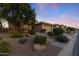 Charming single-story home with a well-manicured xeriscaped front yard and a two-car garage at 3711 N 162Nd Ln, Goodyear, AZ 85395