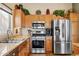 Kitchen area features stainless steel appliances, light wood cabinets and granite countertops at 3711 N 162Nd Ln, Goodyear, AZ 85395