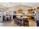 Open kitchen and dining area featuring an island with stool seating and granite countertops at 3711 N 162Nd Ln, Goodyear, AZ 85395