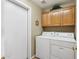 Practical laundry area with washer, dryer, and overhead storage cabinets at 3711 N 162Nd Ln, Goodyear, AZ 85395