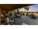 Covered patio, perfect for outdoor entertaining, with patio furniture and a built-in grill overlooking the golf course at 3711 N 162Nd Ln, Goodyear, AZ 85395