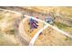 An aerial view of a community playground that includes slides, swings, benches, and shade at 38572 N Jessica Ln, San Tan Valley, AZ 85140