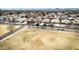 An aerial view of a neighborhood with similarly styled homes and some grass lots for open space at 38572 N Jessica Ln, San Tan Valley, AZ 85140