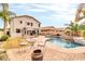 Expansive backyard featuring a pool, patio, lounge seating, and lush landscaping, ideal for outdoor living at 38572 N Jessica Ln, San Tan Valley, AZ 85140