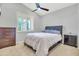 Calm bedroom with carpet, ceiling fan, and shuttered windows creating a peaceful retreat at 38572 N Jessica Ln, San Tan Valley, AZ 85140