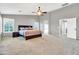 Large bedroom with a ceiling fan, neutral colors, and multiple windows providing ample natural light at 38572 N Jessica Ln, San Tan Valley, AZ 85140