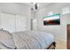 Bright bedroom with a large TV, neutral color palette, and closet with sliding doors at 38572 N Jessica Ln, San Tan Valley, AZ 85140