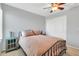 Neutral bedroom with a metal bed frame, side tables, and closet with sliding doors at 38572 N Jessica Ln, San Tan Valley, AZ 85140