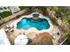 Aerial shot of a backyard pool featuring a spa, lush landscaping, and patio furniture at 38572 N Jessica Ln, San Tan Valley, AZ 85140