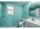 Bright bathroom with blue walls, modern sink, and vanity at 40564 W Nicole Ct, Maricopa, AZ 85138