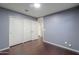 Bedroom with wood-look flooring and a closet with sliding doors at 40564 W Nicole Ct, Maricopa, AZ 85138