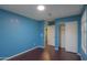 Bedroom features a closet, sleek flooring, and modern lighting at 40564 W Nicole Ct, Maricopa, AZ 85138