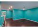 Large room with sleek floors, turquoise walls and recessed lighting at 40564 W Nicole Ct, Maricopa, AZ 85138