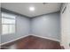 Bedroom featuring wood-look flooring and a bright window at 40564 W Nicole Ct, Maricopa, AZ 85138