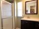 Bathroom featuring a shower, a vanity with a dark wood cabinet, and a framed mirror at 422 S 76Th Way, Mesa, AZ 85208