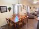 Charming dining room with wood table and seating, illuminated by a modern chandelier at 422 S 76Th Way, Mesa, AZ 85208