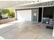 Attached one-car garage with a white door plus a convenient covered carport at 422 S 76Th Way, Mesa, AZ 85208