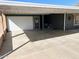 Attached one-car garage with a white door plus a convenient covered carport at 422 S 76Th Way, Mesa, AZ 85208