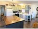 Charming kitchen featuring a center island, light-colored cabinetry, and modern appliances at 422 S 76Th Way, Mesa, AZ 85208