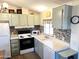 Well-lit kitchen with stylish backsplash, modern appliances, and ample counter space at 422 S 76Th Way, Mesa, AZ 85208