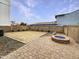 Backyard with desert landscaping, brick pavers, block fence, and modern fire pit at 4233 E Covina St, Mesa, AZ 85205