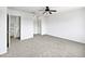 This bedroom features a ceiling fan and neutral carpet at 4233 E Covina St, Mesa, AZ 85205