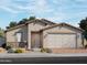 Charming single-story home boasts a neutral color scheme, complemented by stone accents and a spacious two-car garage at 4264 W Hannah St, San Tan Valley, AZ 85144