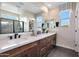 Double vanity bathroom featuring modern fixtures, stylish mirrors, and plenty of counter space at 44327 N 43Rd Dr, Phoenix, AZ 85087