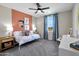 Brightly lit bedroom with an accent wall, plush carpet, a ceiling fan, and a view of the landscape outside at 44327 N 43Rd Dr, Phoenix, AZ 85087