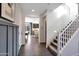 Inviting foyer with staircase, tiled floor, and view of the dining area at 44327 N 43Rd Dr, Phoenix, AZ 85087